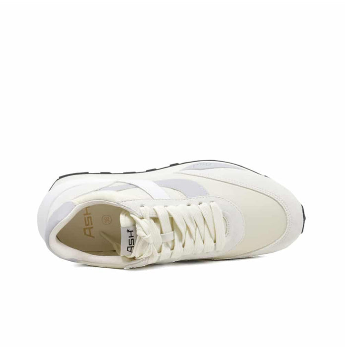 White leather womens sneaker interior view with lace-up opening and branded tongue