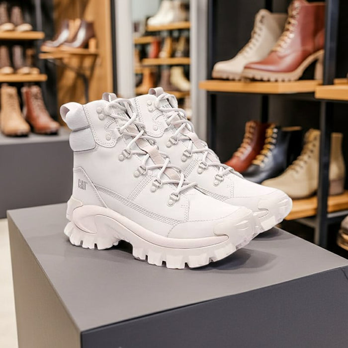Women's lace-up winter boots on display, light grey synthetic upper with thick tread sole