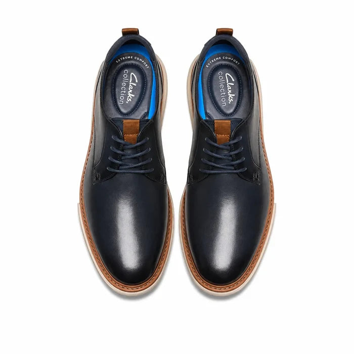 Pair of men's lace-up leather shoes, dark blue uppers with tan edge sole