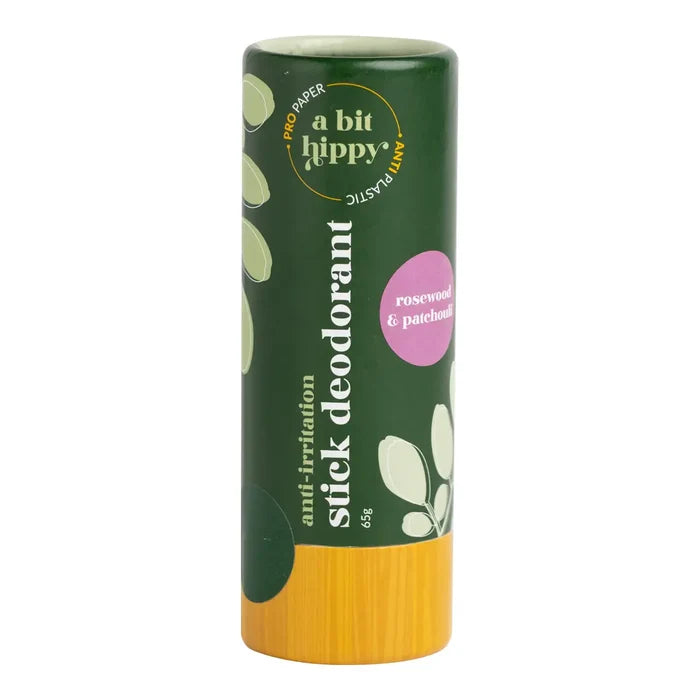 A stick deodorant in a dark green container with a pink 'rosewood & patchouli' label, shown on a plain white background.