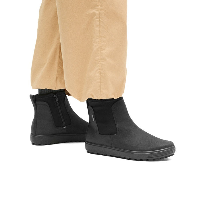 Pair of women's black Chelsea boots with elastic gore and rugged tread sole