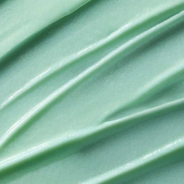 Close-up of light green serum with visible texture.