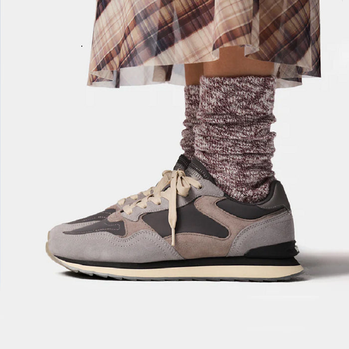 Women's lace-up leather sneakers in gray, purple, and black with tan laces.