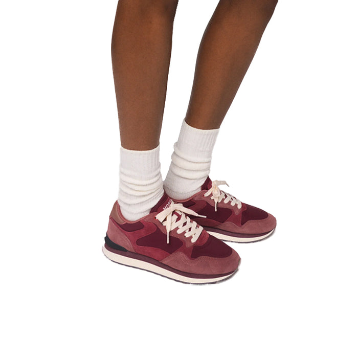 Women’s sneakers with white crew socks and burgundy lace-up uppers