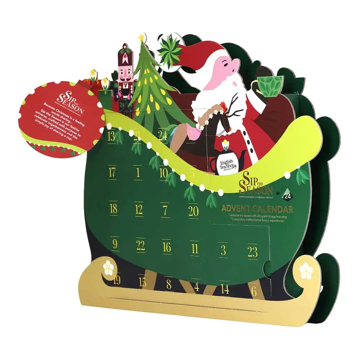 A Christmas advent calendar shaped like a green sleigh with gold wheels and base.