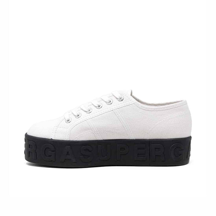 Women’s white lace-up low-top sneakers with dark rubber sole and subtle stitching